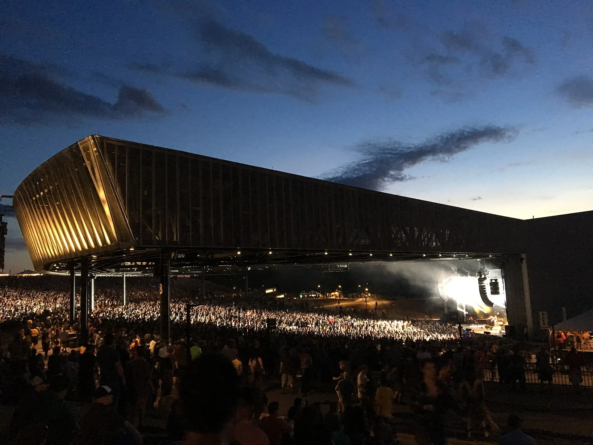 Concert crowd at Empower FCU Amphitheater at Lakeview in Syracuse, New York at sunset