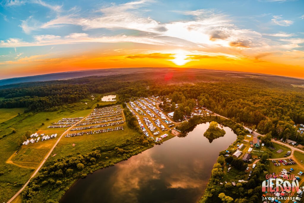 Aerial view of the Great Blue Heron Music Festival grounds at sunset in Sherman, New York