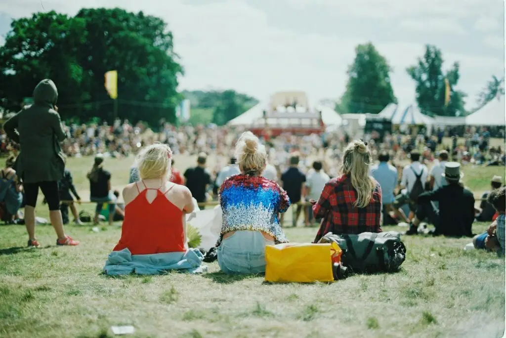 Outdoor crowd enjoying a daytime performance at a folk music festival on the fairgrounds