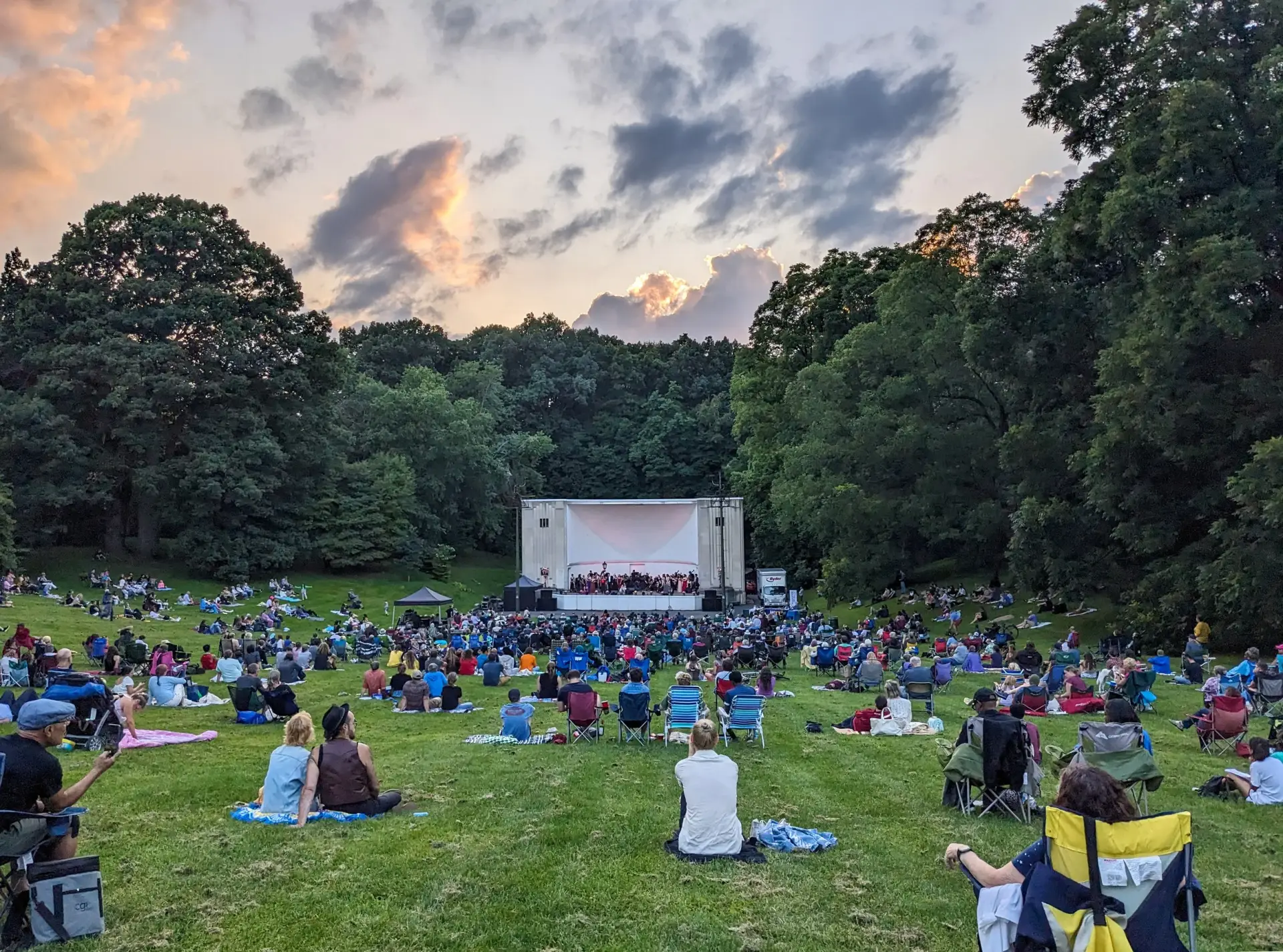 Highland Bowl Amphitheater in Rochester, New York — art-deco bandshell at the base of a natural grass amphitheater inside Highland Park