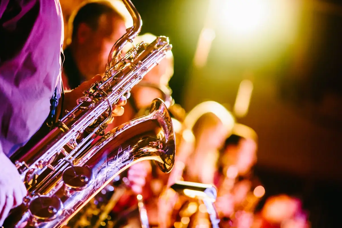 Saxophone player performing under dramatic stage lighting