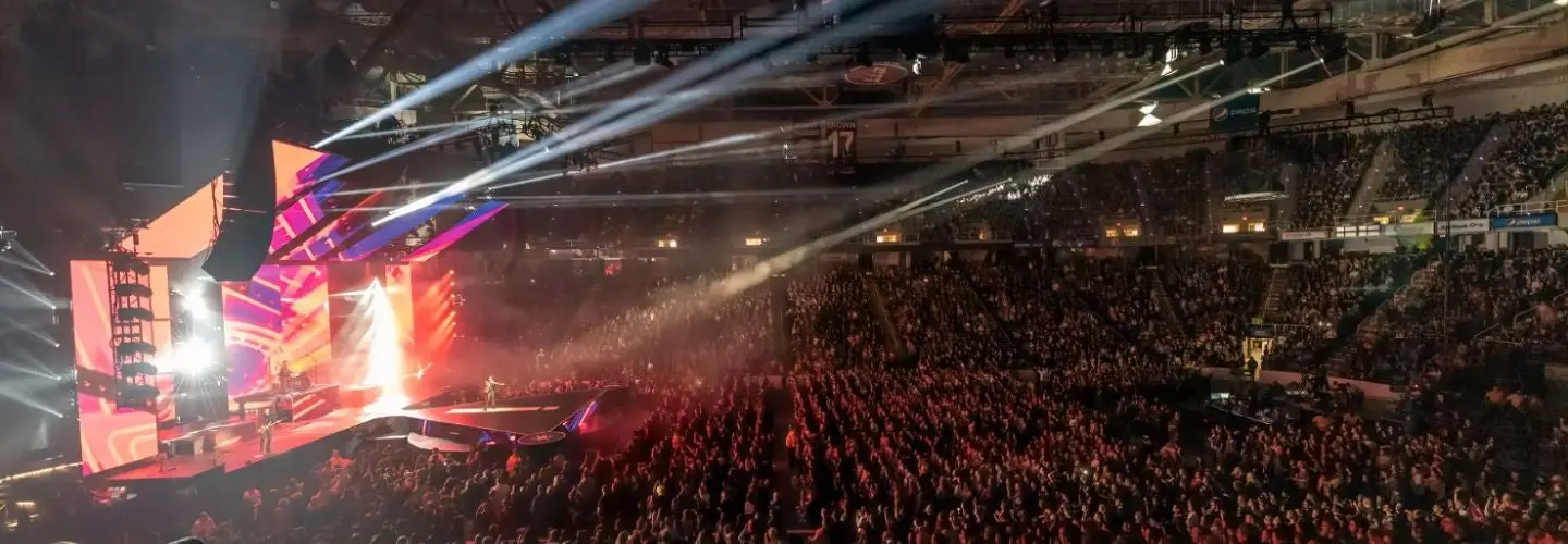 MVP Arena interior during a concert showing the packed bowl seating and floor crowd with dramatic stage lighting
