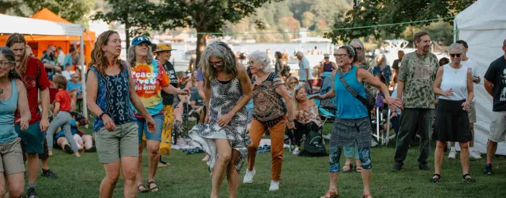 Crowd dancing at Northern Current music festival in Riverside Park on Lake Flower, Saranac Lake
