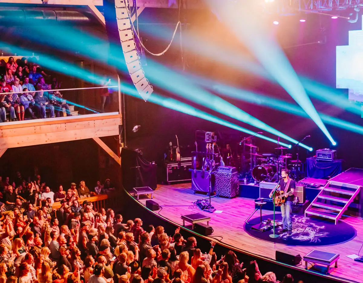 Penn's Peak main concert hall interior during live performance with stage dance floor and mountain-lodge timber ceiling