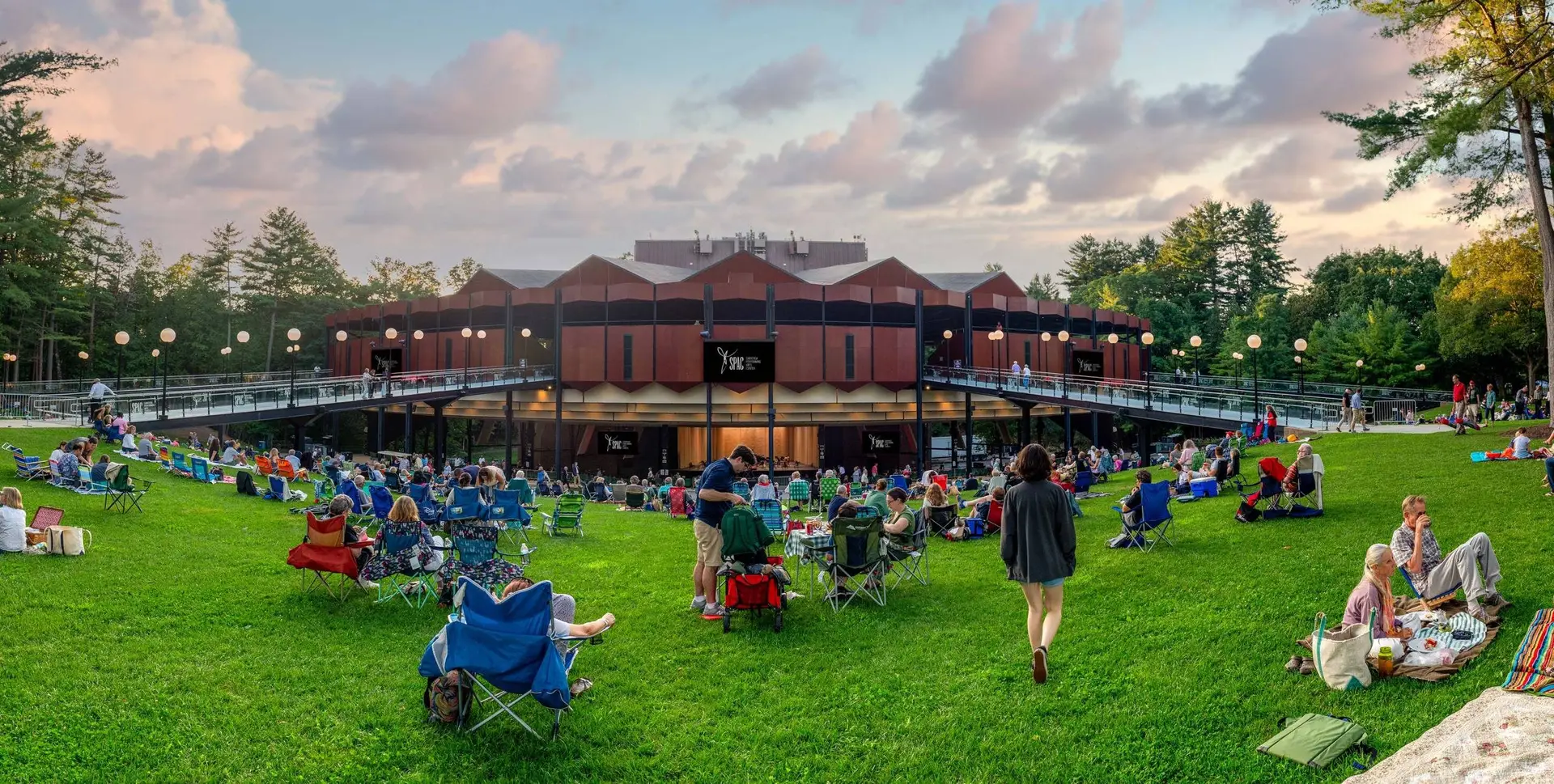 SPAC lawn and amphitheater filled with concertgoers during a summer evening performance at Saratoga Performing Arts Center in Saratoga Springs New York