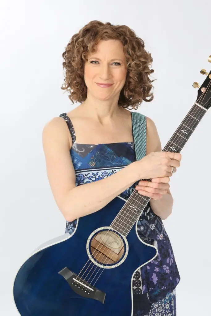Laurie Berkner performing live with acoustic guitar