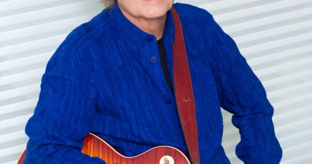 Lee Ritenour performing live with guitar