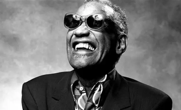 Ray Charles performing, mid-1980s — signature dark sunglasses, broad smile