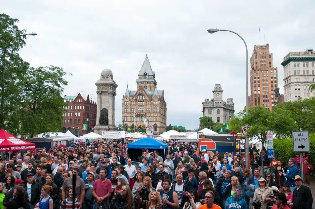 Massive crowd packed into Clinton Square at Taste of Syracuse with the Soldiers and Sailors Monument behind festival tents
