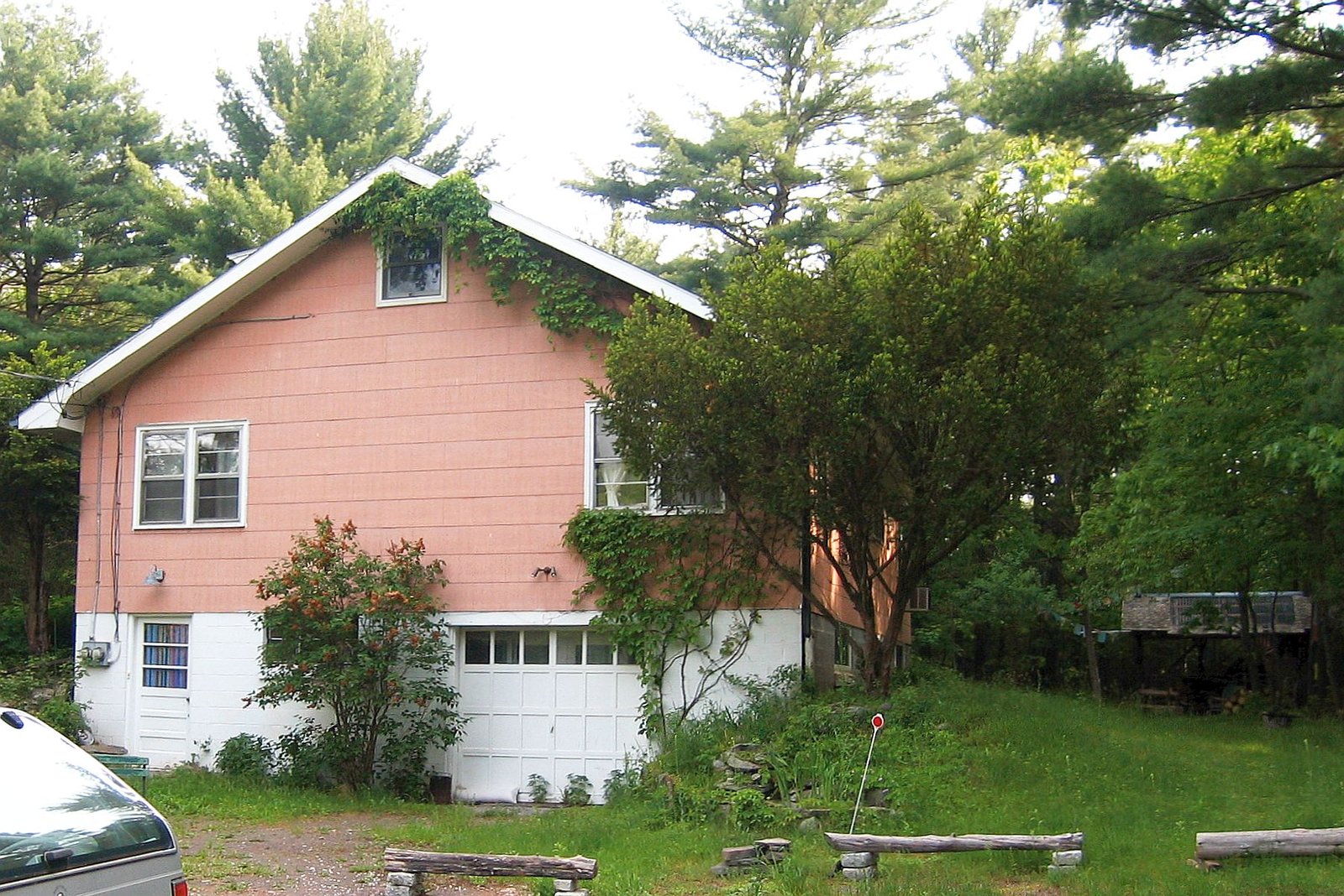 Exterior of Big Pink, a salmon-colored two-story farmhouse in West Saugerties, NY, photographed in 2006