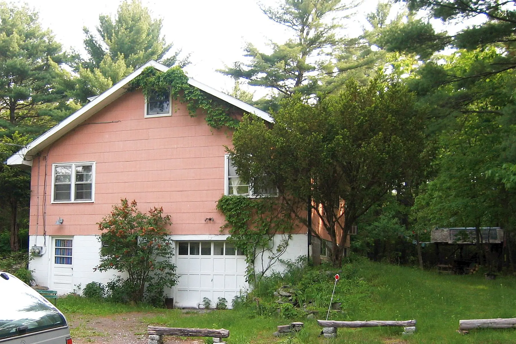 Exterior of Big Pink, a salmon-colored two-story farmhouse in West Saugerties, NY, photographed in 2006