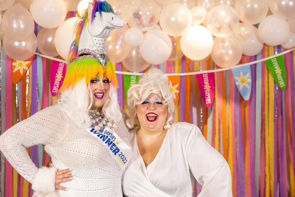 Emoji Nightmare and Katniss Everqueer in drag performance attire at a Vermont event