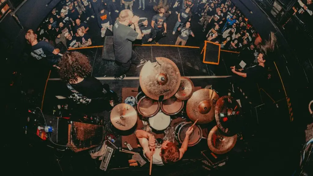 Orthodox performs live at a metal show, overhead stage view with drummer and vocalist