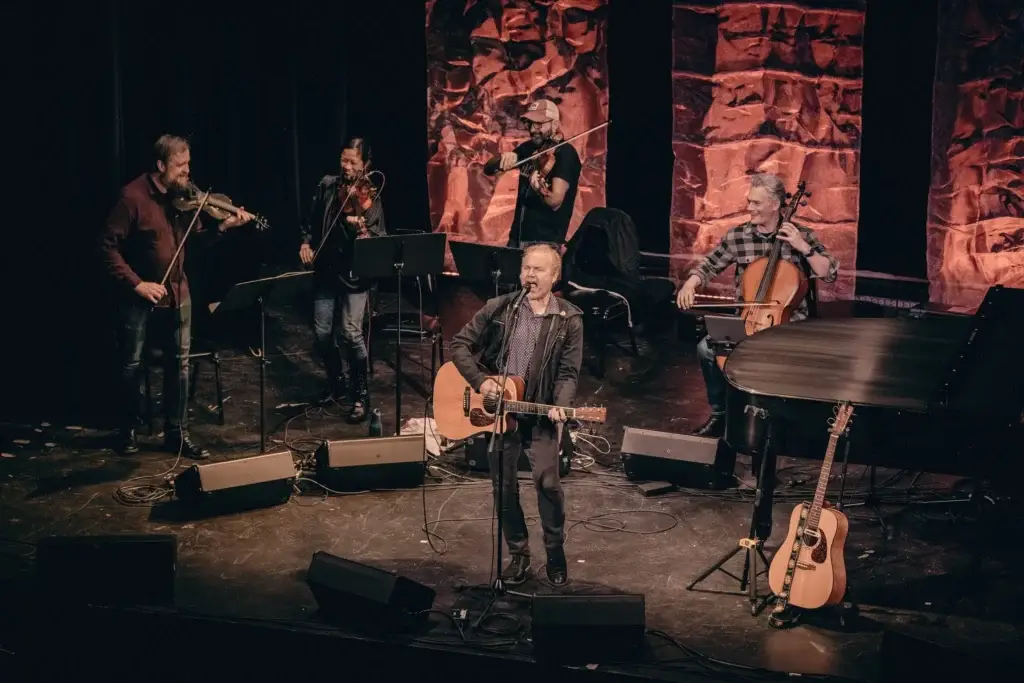 Five For Fighting performs with string quartet on stage, John Ondrasik on acoustic guitar at center