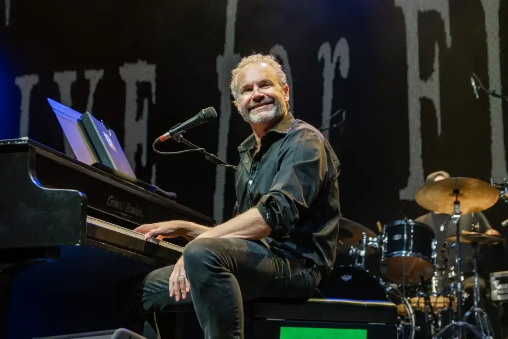 Five for Fighting's John Ondrasik performs at piano on stage