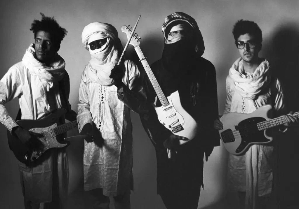 Mdou Moctar and band in traditional Tuareg dress with electric guitars — official Matador Records press photo