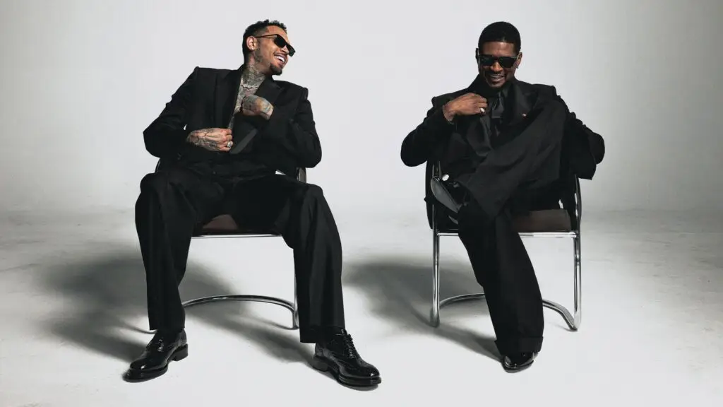 Usher Raymond and Chris Brown pose in black suits for The R&B Tour 2026