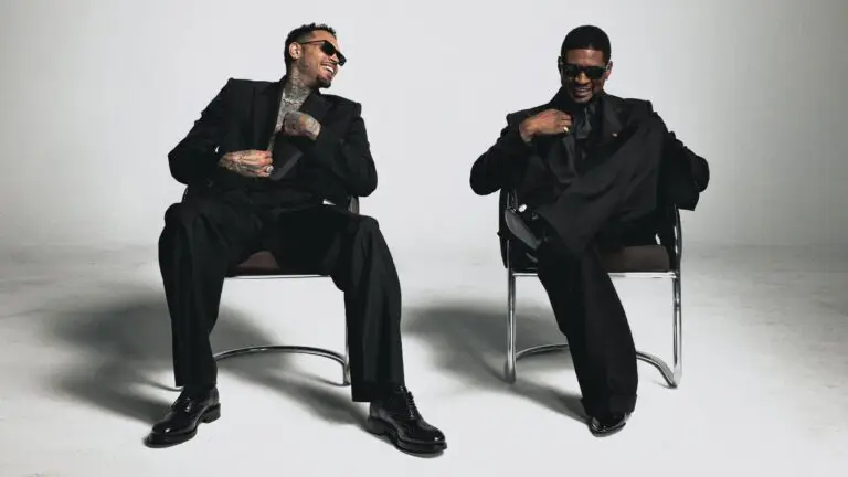 Usher Raymond and Chris Brown pose in black suits for The R&B Tour 2026