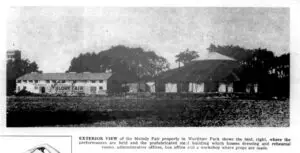 Black-and-white photograph of the Melody Fair building and tent, North Tonawanda, New York, 1956, with prominent MELODY FAIR signage on the side of the building and a large circus-style tent at right.