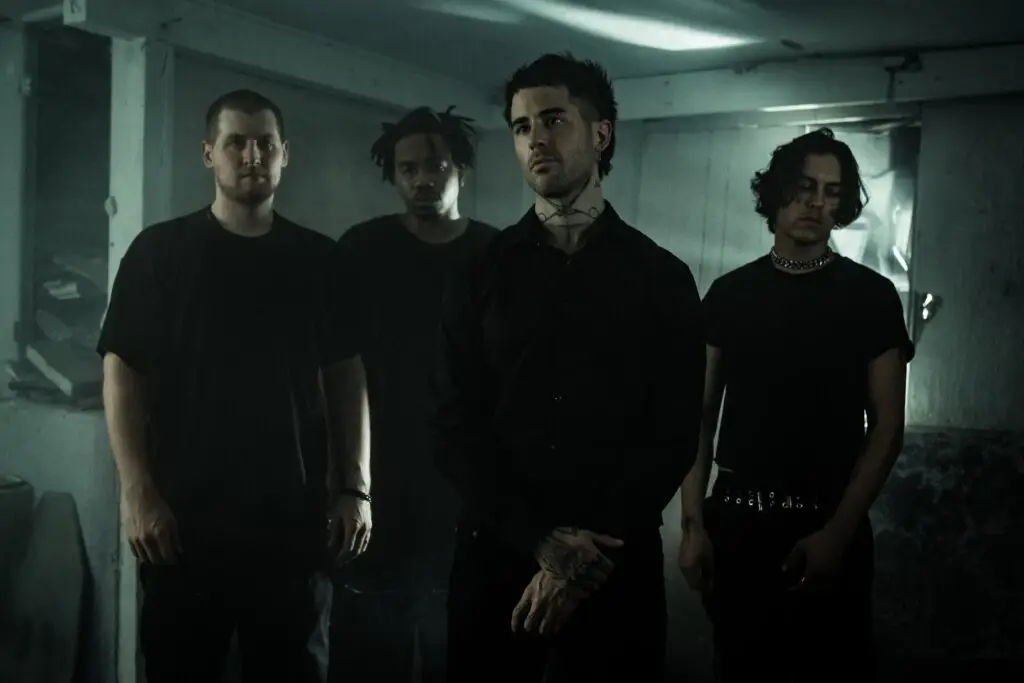 Holywatr band promo photo — four members in dark attire for the Deo Gratias Tour