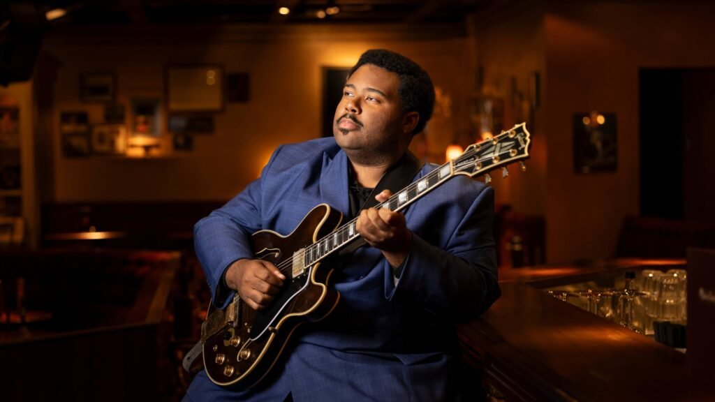 D.K. Harrell plays guitar at Funk 'n Waffles in Syracuse, NY