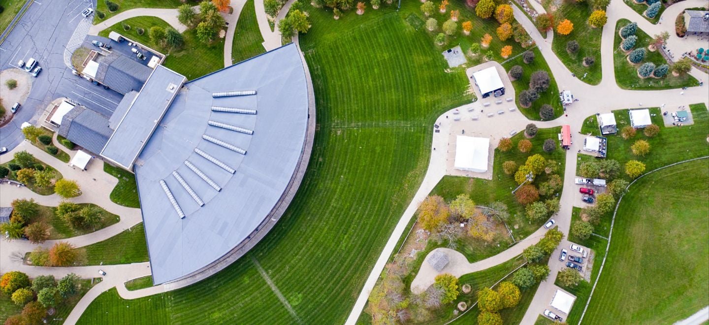 Bethel Woods Center for the Arts pavilion stage with audience, evening atmosphere — the venue built on the 1969 Woodstock festival site in Bethel, NY.