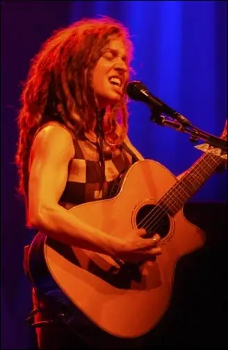 Singer-songwriter and Buffalo native Ani DiFranco performing live with an acoustic guitar.