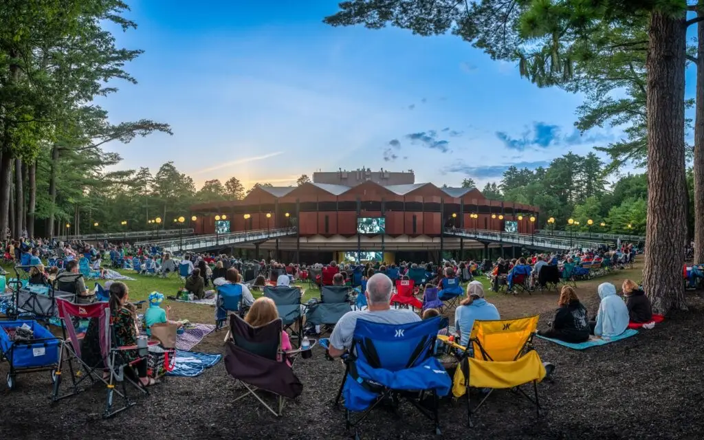The Saratoga Performing Arts Center amphitheater at dusk with a full lawn crowd, Saratoga Springs, NY