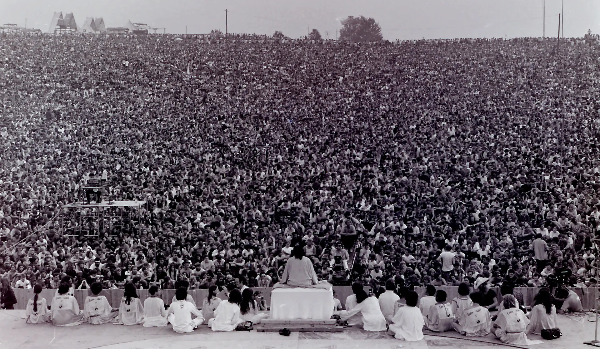 The Woodstock 1969 crowd filling the bowl during Swami Satchidananda's opening invocation