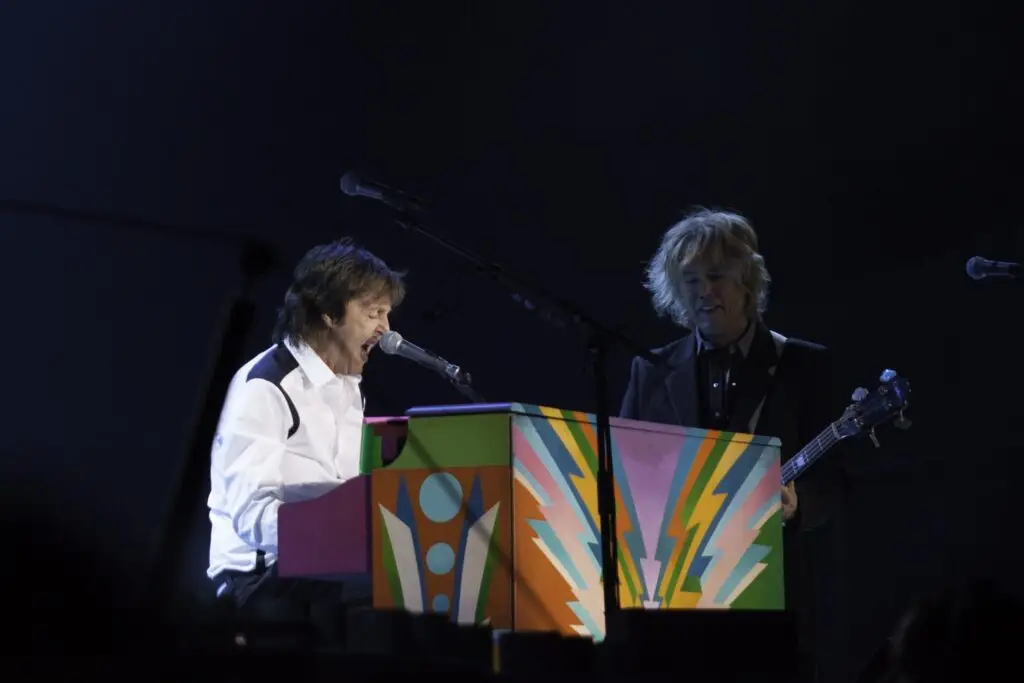 Paul McCartney performing at a colorful piano on his 2014 Out There tour