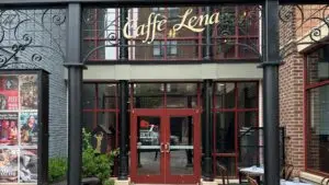 The entrance to Caffè Lena at 47 Phila Street in Saratoga Springs, beneath a wrought-iron arch bearing the venue name