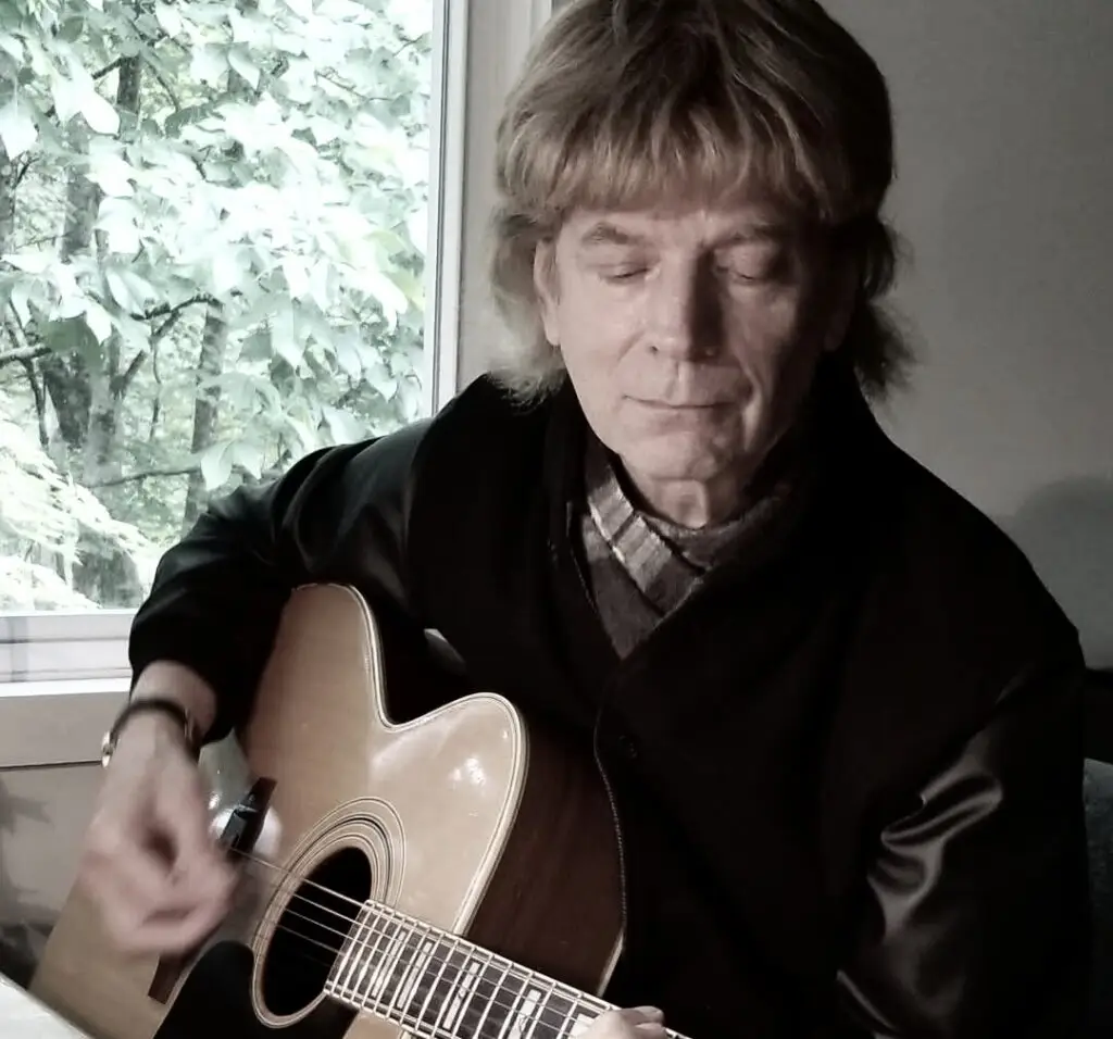 Tim Moore playing acoustic guitar, Woodstock singer-songwriter