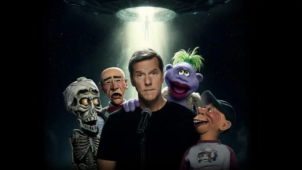 Jeff Dunham at a microphone with ventriloquist characters Achmed, Walter, Peanut, and Bubba J for his Inappropriate Contact tour