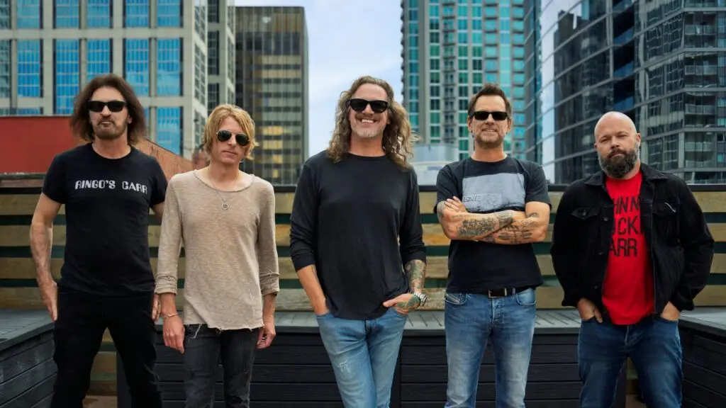 Candlebox band members pose on a rooftop against a city skyline, promotional photo 2026
