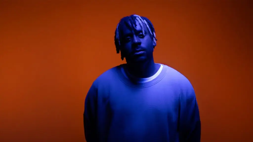 Myles Smith in official promotional portrait with dramatic blue and orange studio lighting
