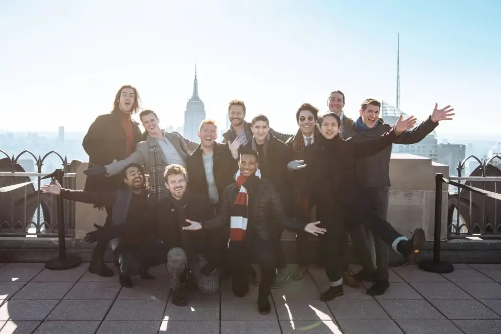 Chanticleer ensemble poses on a New York City rooftop with the Empire State Building skyline