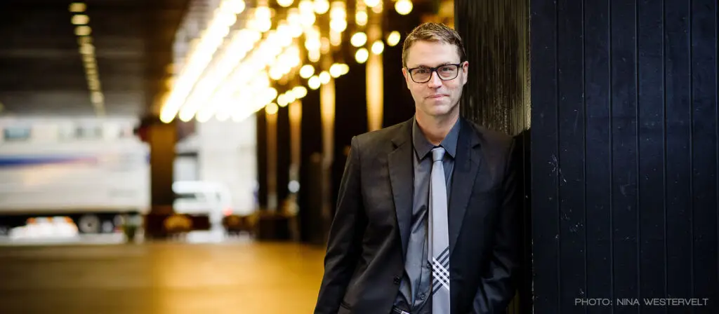 Deke Sharon, a cappella music director and Pitch Perfect producer, in front of theater marquee lights