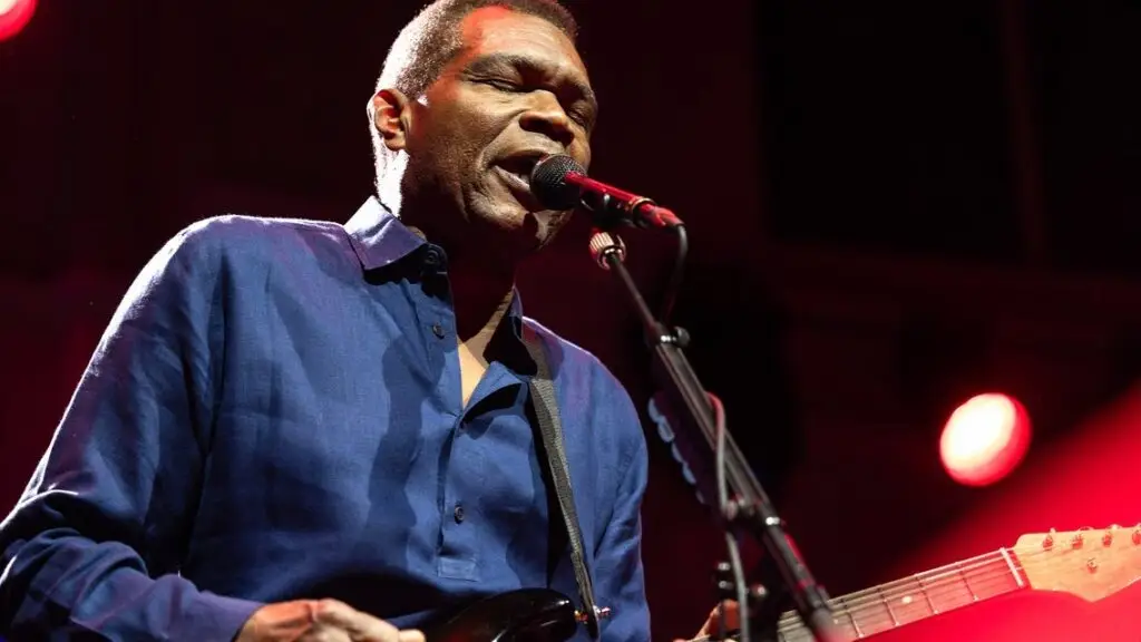 Robert Cray performing live on stage with guitar and microphone