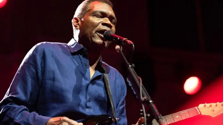 Robert Cray performing live on stage with guitar and microphone