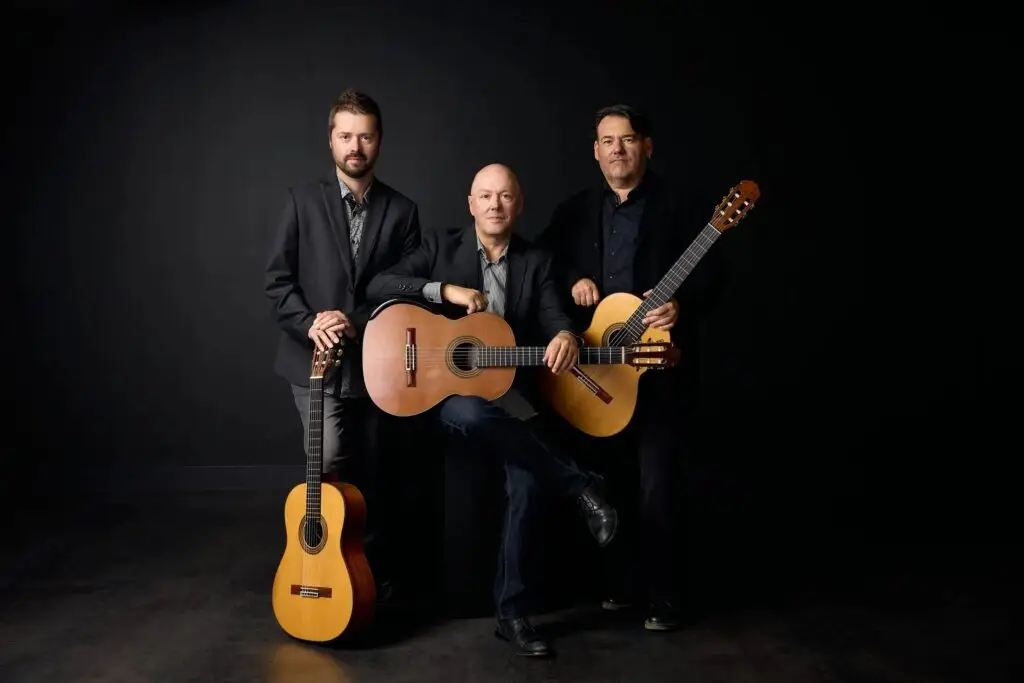 Montréal Guitar Trio in studio press photo with their classical guitars