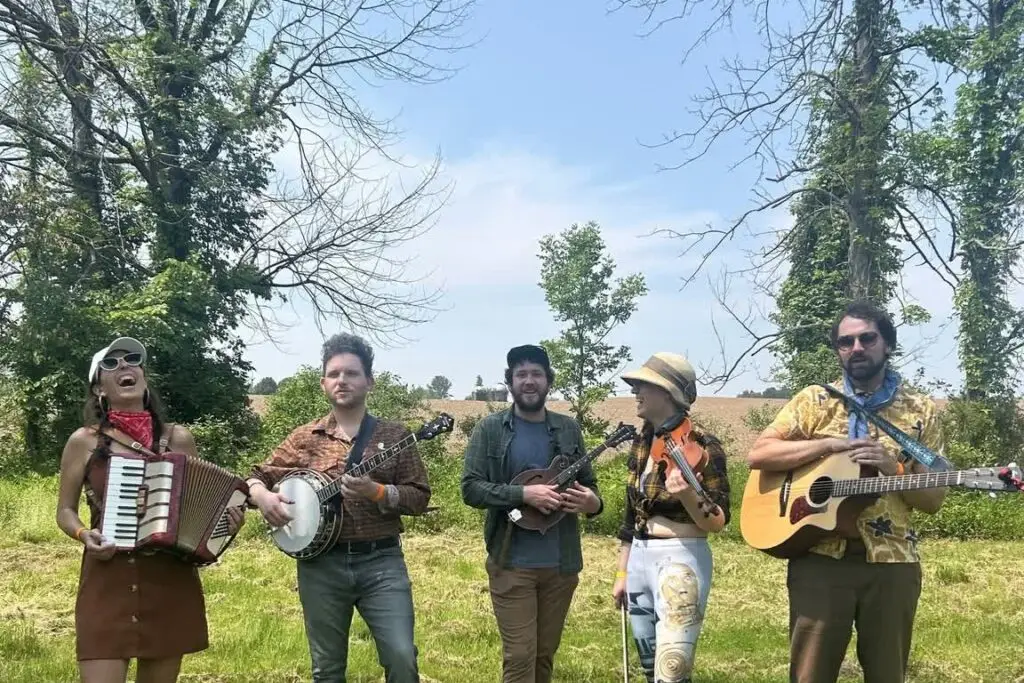 Heart Throbs String Band performs outdoors with accordion, banjo, fiddle, and guitar