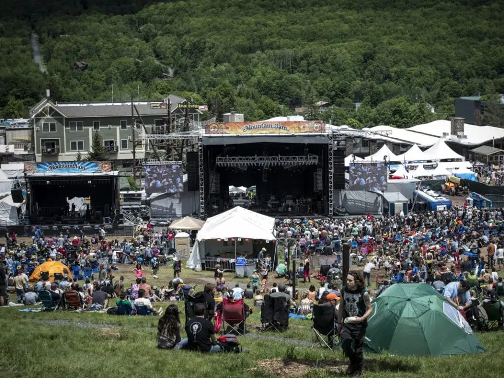 The Mountain Jam crowd on the hillside with the Mountain Jam banners over the stages, Hunter Mountain