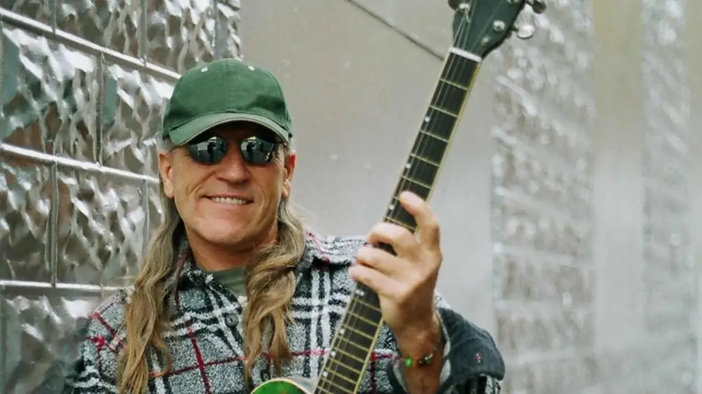 Mark Farner of Grand Funk Railroad plays guitar during a live performance