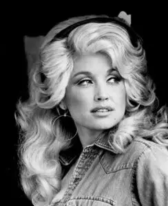 Dolly Parton in a denim jacket and hoop earrings, RCA Records publicity portrait from 1977