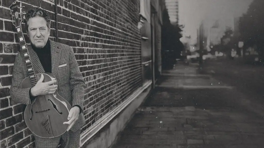 John Pizzarelli with archtop jazz guitar, official press photo for show at Mahaiwe Performing Arts Center