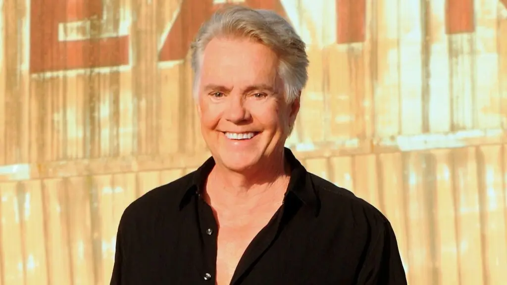 Shaun Cassidy official press photo, silver hair, warm smile, black shirt