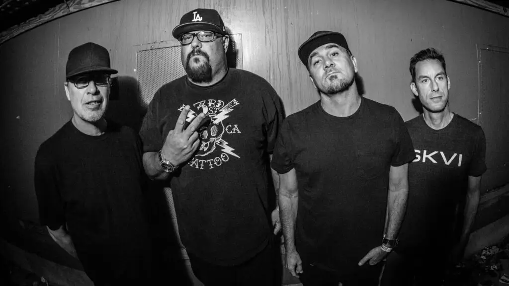 Pennywise four-piece band press photo, B&W fisheye lens, four members backstage in casual punk attire