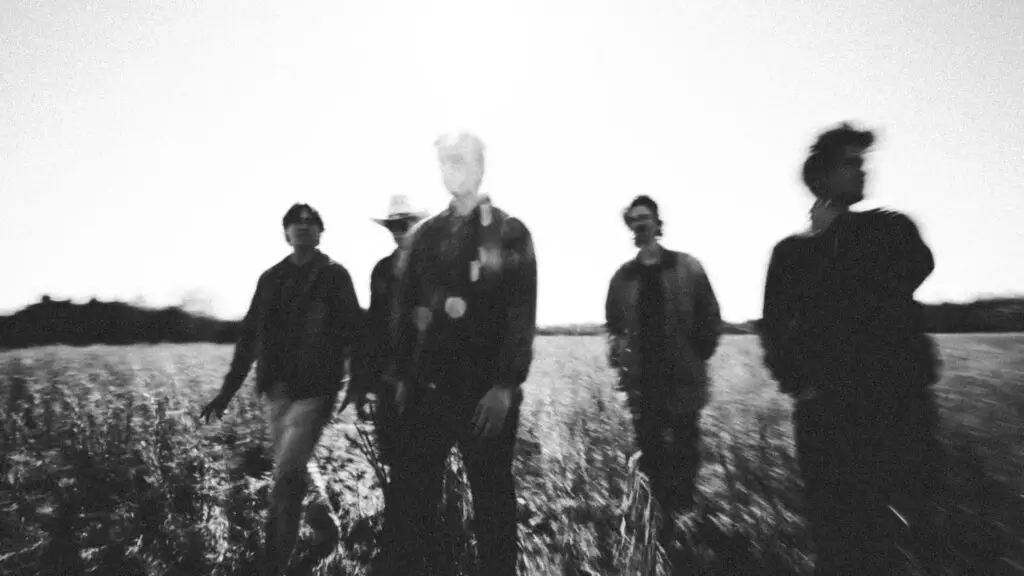 Winyah band photo, five members standing in a field, black and white