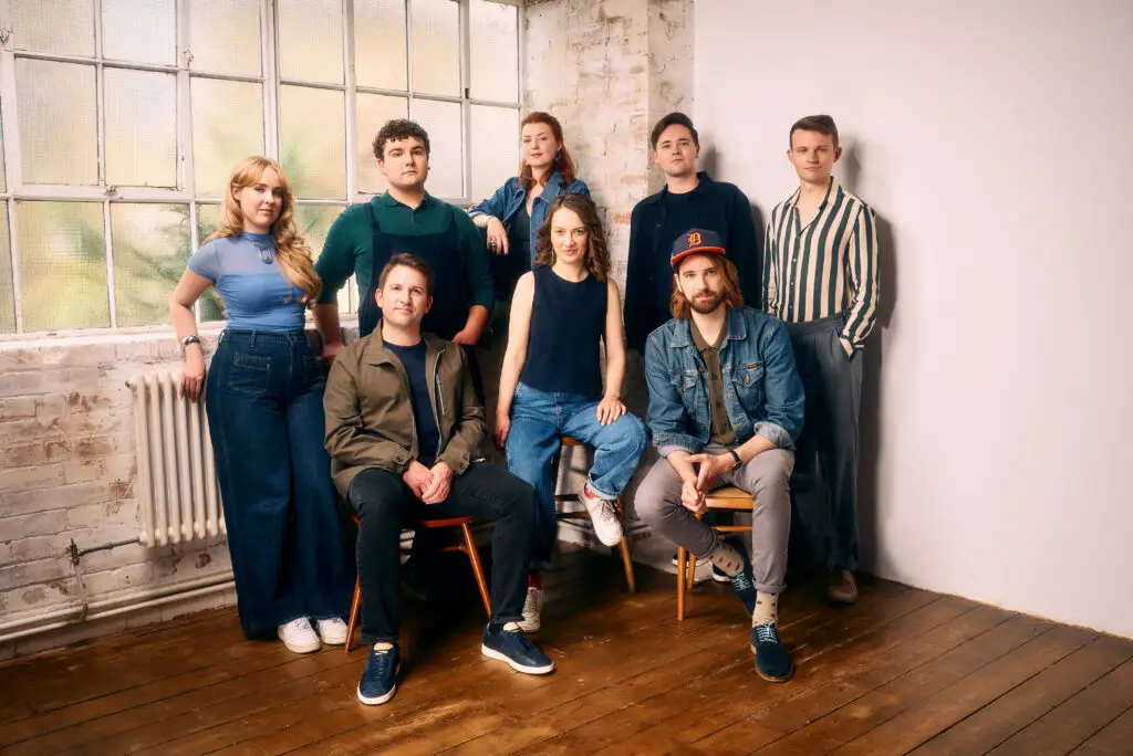 VOCES8 vocal ensemble — all eight members posed together in a bright studio setting