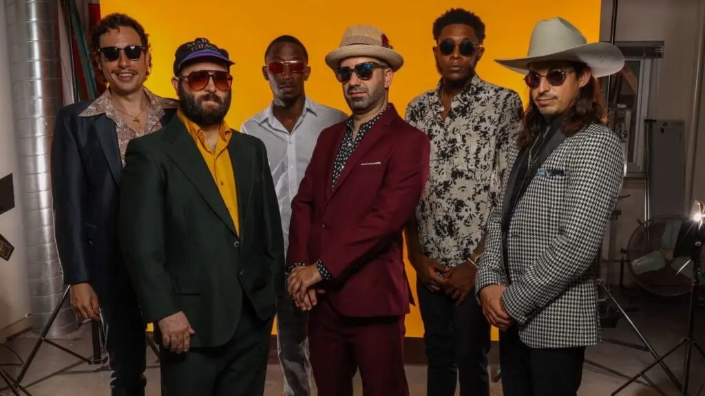 Flow Tribe six-piece New Orleans funk band in colorful suits and sunglasses, 2022 press photo